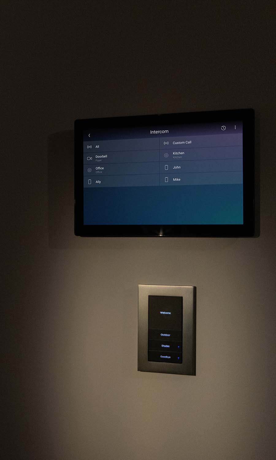 Control4 Touch panel in a able with a traditional home in the background