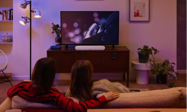 Couple watching TV in a room tinted purple