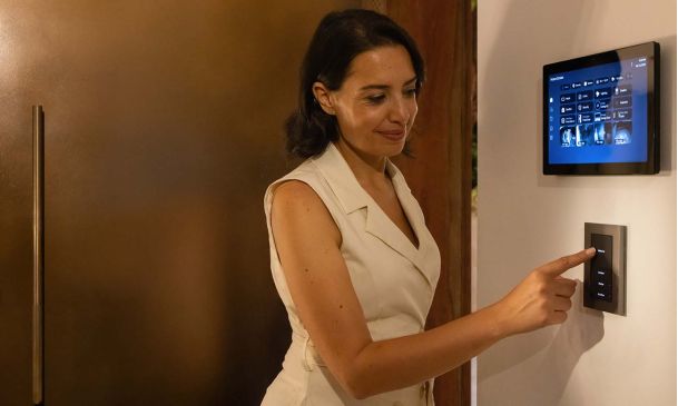 Woman pressing a button on a Control4 Lux keypad