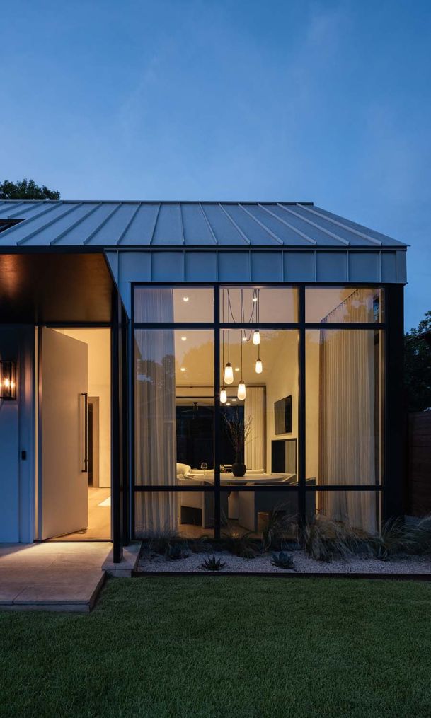 Lutron lighting in a home at dusk with large glass windows