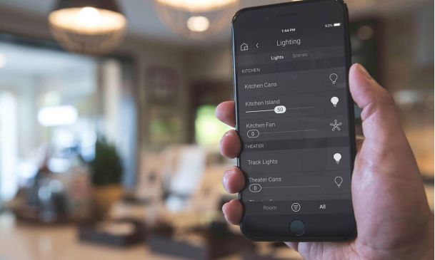 Man holding a phone with a Control4 lighting control interface